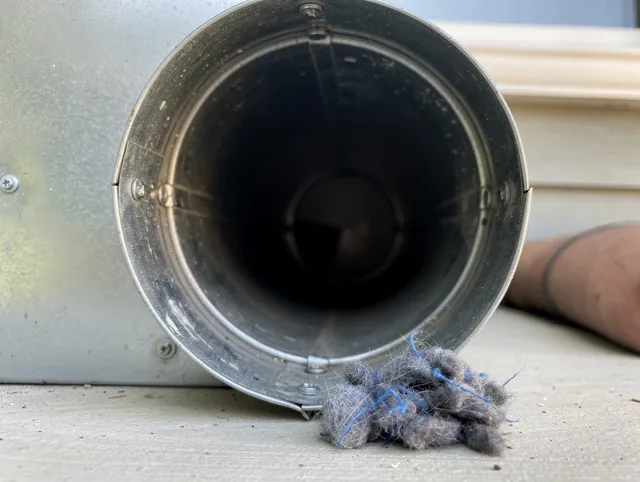 Mint Hill Dryer Vent Cleaning technician using specialized equipment to clear severe dryer vent blockage in Mint Hill
